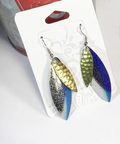 Fishing lure earrings fishing jewelry lure earrings made from brand new willow blades two tone Blue and hammered Brass Spinner Lures Limited Stock Send the Chart for blade sizes The ear wires are fish hook type Sterling Silver nickel free The earrings are approximately 2 1/4 inches in length Wear out to the lake, pairs nicely with your favorite shorts or casual wear Click the link below to view my New Spinner Lure Bracelet 🐟 Listing: https://www.etsy.com/listing/613780424/fishing-lure-spinner-b Fishing Jewelry, Fishing Earrings, Fish Lure Jewelry, Fishing Lures Art, Blue Drop Earrings With Fish Hook, Fishing Lure Earrings, Fish Hook Jewelry, Resin Fishing Lures, Fishing Lure Necklace