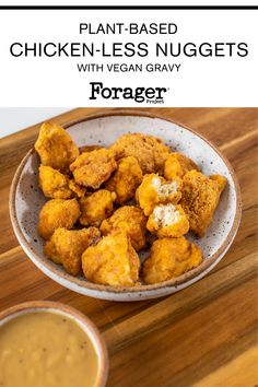 chicken nuggets with vegan gravy in a bowl on a wooden table