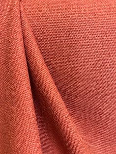 an orange fabric textured up close to the camera with focus on the center piece