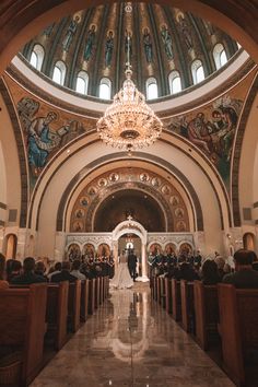 the bride and groom are walking down the aisle at their wedding ceremony in an ornate church