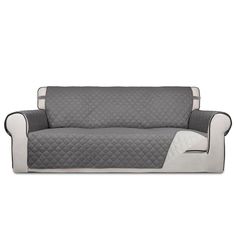 a couch covered in grey and white quilting