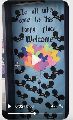 a door decorated with mickey mouse balloons and the words, to all who come to this happy place welcome