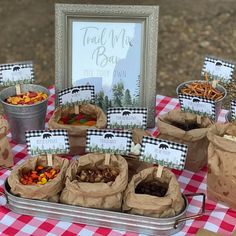 there are many bags with food in them on the table and one has a sign that says feed me bear