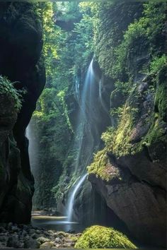 there is a waterfall in the middle of some rocks