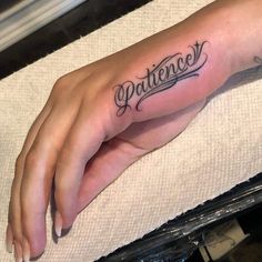 a woman's hand with the word patience tattooed on it