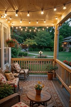 a porch with lights strung over it and furniture on the front porch, along with potted plants