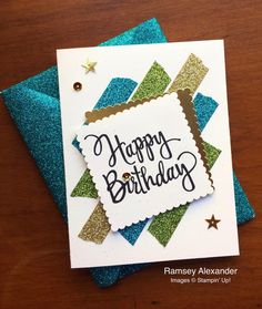 a happy birthday card on top of a table with blue and green glittered paper