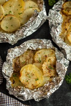 three foil packets filled with potatoes and meat