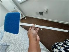 a person is measuring the height of a bed in a room with an air conditioner