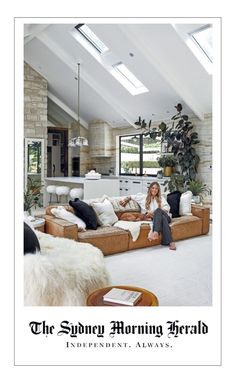 a woman sitting on top of a couch in a living room