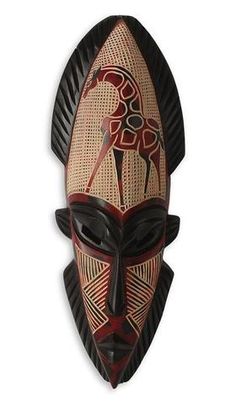 an african mask with black and red designs on the face, against a white background