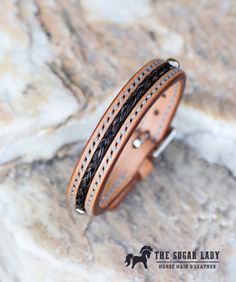 "This 1/2\" leather bracelet is made from European leather is hand stamped and hand stitched with horse hair inlaid into the leather. Perfect for the cowboy in your life! If you would like a different color thread or leather, just let me know and I'll be happy to make it happen. Please include your wrist size and whether you plan to use your own horse' s hair or hair from my own collection. I have a wide variety of colors to chose from. If using your own hair, tail hair of at least 10 inches of Horsehair Bracelet, Horse Hair Braiding, Horsehair Jewelry, Equine Jewelry, Hair Tail, Mane Hair, Horse Hair Bracelet, Horse Hair Jewelry, Hair Bracelet