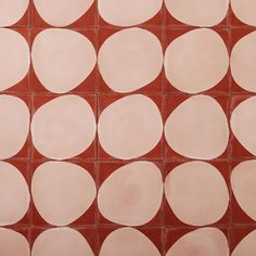 a red and white tiled wall with circles on it