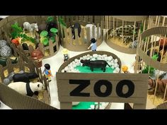 an animal exhibit with zoo animals and people