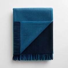 a blue and black blanket with fringes