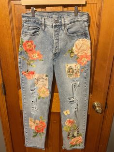 an old pair of jeans with flowers on them