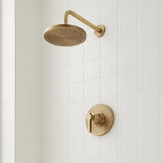 a shower head with thermostaer and hand held shower faucet in an all white bathroom