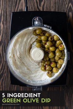 an overhead view of green olives in a food processor with the words, 5 ingredient green olive dip