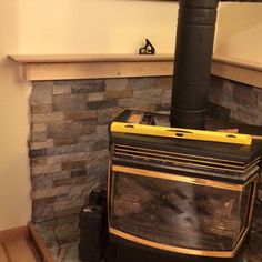 a wood burning stove sitting inside of a kitchen