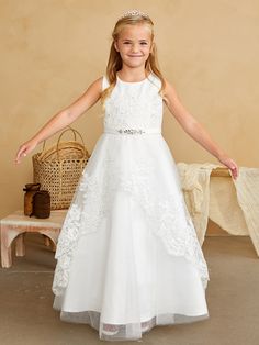 Celebrate a milestone in elegance with the Davina Communion Dress, a cherished piece from the Blush Kids collection, perfect for your child's special day. This full-length dress features a beautifully crafted lace bodice that whispers tales of timeless sophistication. Complementing the exquisite bodice, the lace peplum overlay skirt adds a touch of traditional charm and grace, ensuring your little one looks angelic during her First Communion. The intricate lace details are designed to create a h Baby Christening Outfit, Girls Communion Dresses, Holy Communion Dresses, Girls Ball Gown, Flower Girl Crown, Overlay Skirt, Christening Outfit, Girls Pageant Dresses, Christening Dress