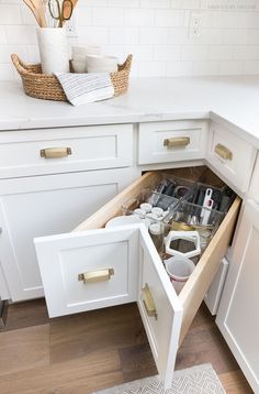 an open drawer in the middle of a kitchen