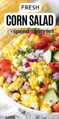 corn salad with tomatoes, cucumbers and onions in a white bowl