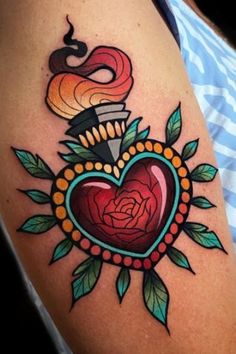 a heart tattoo on the arm with roses and leaves around it, surrounded by a snake