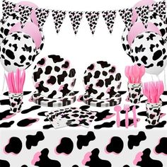 the table is decorated with pink and black polka dot decorations, including zebra - print napkins