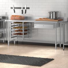 a kitchen with stainless steel counters and shelves