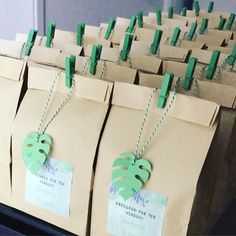 brown paper bags with green tags and numbers on them are lined up in the shape of leaves