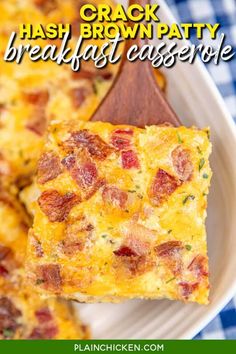 a white plate topped with breakfast casserole next to a wooden spoon