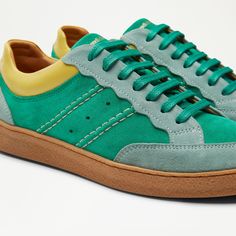 Meet Roller, the lace up counterpart to Roll Up. Set to elevate all your looks, with its versatile sleek silhouette, and ultra feminine scalloped detailing. Cut from shades of green suede, and featuring a yelllow leather accent in soft nappa leather. Roller will pair seamlessly with both your casual and dressier ensembles. The Scalloped Sneaker. Green Suede Mix. Yellow Nappa Leather Accent. Leather Lining. Made in Portugal. 242884. Fits true to size.. Suede Sneakers Outfit, Shoe Study, Green Trainers, Mom Shoes, Summer Footwear, Shoe Shine, Green Sneakers, Shoe Boot Sandals, Winter Outfits For Work