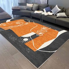 an orange and black area rug in the middle of a living room with couches