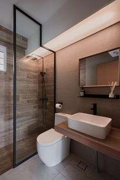 a bathroom with a toilet, sink and shower