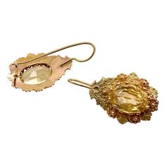 This is part of Chairish’s Fine Jewelry assortment.  A wonderful pair of Victorian period pierced earrings with a prong set citrine in the center.  The tear drop setting has Etrsucan beadwork alternating yellow and rose gold flowers.  The wires are French with a hook at the bottom.  They test 14K but have no marks.  Condition is excellent.  The citrines measure 10 mm X 8 mm, or 2.4 carats.  Dimensions: Length from top of wire, 1 1/4", The drop measures 1" by 5/8", Weight: 2.4 grams Fine Jewelry Citrine Earrings For Wedding, Citrine Wedding Earrings Fine Jewelry, Citrine Fine Jewelry Earrings For Wedding, Wedding Fine Jewelry Citrine Earrings, Citrine Drop Earrings For Wedding, Elegant Citrine Earrings For Wedding, Formal Teardrop Citrine Earrings, Elegant Citrine Jewelry With Rose Cut Diamonds, Elegant Oval Citrine Earrings