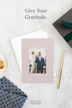 a thank card on top of a table next to a plate of food