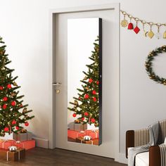 a decorated christmas tree sitting next to a doorway