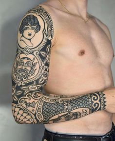 a man with tattoos on his arm and shoulder