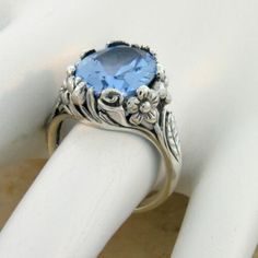 Vintage Estate 7.00 Carat Simulated Sky Blue Topaz Solitaire Filigree Ring. Floral Designs. 925 Solid Sterling Silver. Stamped 925. Excellent Condition/Like New. Vintage Sterling Silver Topaz Solitaire Ring, Vintage Sterling Silver Solitaire Topaz Ring, Vintage Sterling Silver Topaz Promise Ring, Classic Silver Blue Topaz Birthstone Ring, Sapphire Topaz Ring In Sterling Silver, Vintage Blue Topaz Ring For Anniversary, Vintage Blue Topaz Birthstone Jewelry, Silver Topaz Birthstone Ring For Formal Occasions, Classic Blue Topaz Jewelry Stamped 925