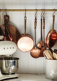 pots and pans are hanging on the wall