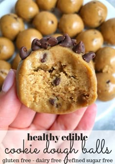 a person holding up a cookie dough ball with chocolate chips on top and text overlay that reads healthy edible cookie dough balls