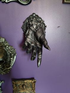 an elephant's hand is hanging on the wall next to other decorative items and mirrors