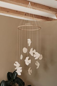 a white bird mobile hanging from the ceiling