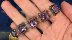 This fantastic vintage bracelet features nine (9) rectangular filigree links each accented with one (1) cut-cornered rectangular modified brilliant cut amethyst set into bezel settings. The links feature a pierced design with engraved details and bordered with milgrain edging. The bracelet measures 6-1/4 inches in length and 15.7mm in width. The bracelet is finished with a spring ring style clasp. The patina on this bracelet is spectacular. Antique Jewelry With Gemstone Accents For Formal Occasions, Luxury Rectangular Amethyst Jewelry, Purple Rectangular Jewelry For Formal Occasions, Formal Rectangular Purple Jewelry, Formal Purple Rectangular Jewelry, Formal Victorian Jewelry With Rectangular Shape, Rectangular Victorian Jewelry For Formal Occasions, Luxury Purple Rectangular Jewelry, Formal Victorian Rectangular Jewelry