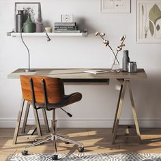 a wooden desk sitting in front of a white wall with pictures on the wall above it