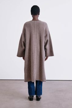 A woven wool and cashmere blend coat with open front, bell sleeves, and blanket stitch detail along the pockets and collar. 90% Wool, 10% Cashmere. 24.5" Bust, 17.5" Sleeve, 28.5" Bottom Width, 44.25" Total Length. One size: Fits sizes XS-XL. Dry clean only. Woven in Inner Mongolia. Fall Cashmere Outerwear With Shawl Collar, Fall Cashmere Long Sweater Coat, Long Cashmere Sweater Coat For Fall, Cashmere Long Sweater Coat For Fall, Oversized Long Sleeve Cashmere Outerwear, Oversized Long Cashmere Outerwear, Cashmere Outerwear For Fall Daywear, Cashmere Outerwear For Daywear In Fall, Oversized Cashmere Sweater Coat For Fall