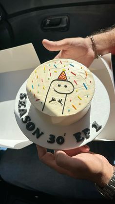 a person holding a cake in their hand