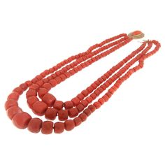 This striking necklace features multiple strands of richly hued Sardinian coral, known for its vivid color and prized throughout history for its natural beauty. The coral beads are meticulously shaped and polished, creating a luxurious cascade of warm, inviting red that lays gracefully upon the collarbone. Each strand varies subtly in the size of its beads, adding depth and texture to the design. The clasp is crafted from 9-karat yellow gold, providing a secure fastening and a gleaming contrast Traditional Coral Single Strand Necklace, Traditional Coral Necklace With Large Beads, Multi-strand Red Coral Necklace With Polished Beads, Traditional Coral Necklace With Gemstone Beads, Traditional Single Strand Coral Jewelry, Traditional Multi-strand Red Coral Necklace, Traditional Multi-strand Red Coral Necklaces, Traditional Multi-strand Red Coral Beaded Necklace, Traditional Coral Necklace With Polished Beads