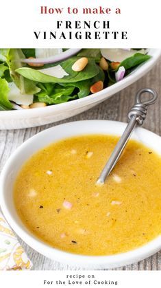 a white bowl filled with soup next to a salad