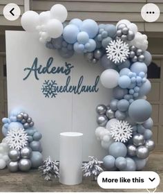 the balloon arch is decorated with snowflakes and balloons